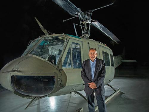 Curator Peter Jakab portrait with the Bell UH-1H Iroquois "Huey" Smokey III helicopter.