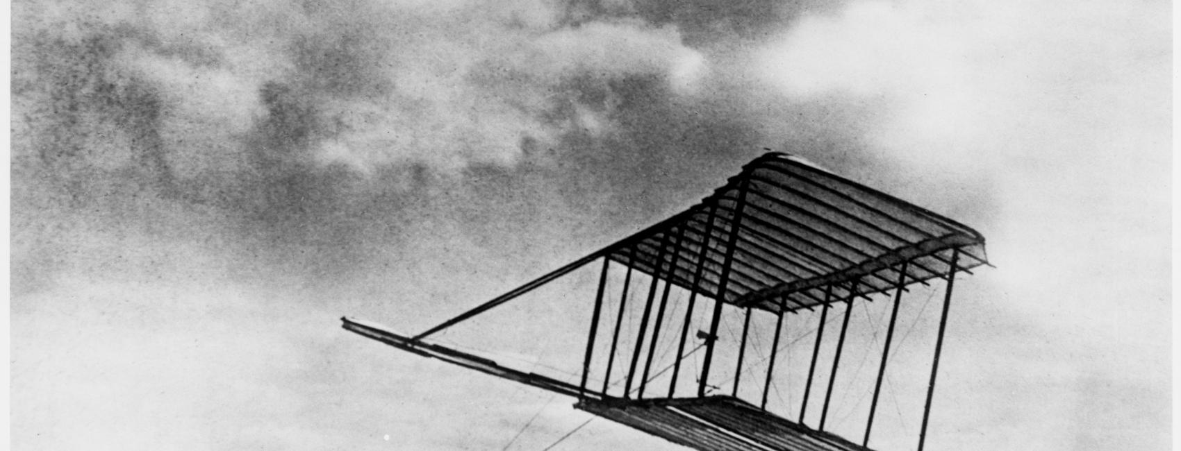One-quarter front left side view of Wright 1900 Glider being flown as a kite.