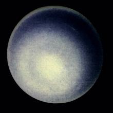 A hazy blueish orb against a dark background.