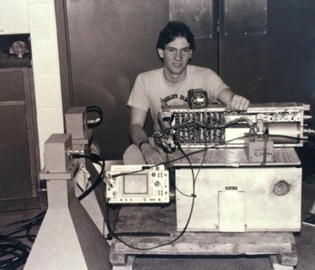 Black and white photo of Bruce sitting behind his radar.